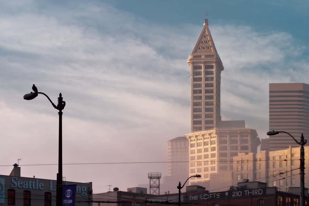 Smith Tower rising above fog into blue sky