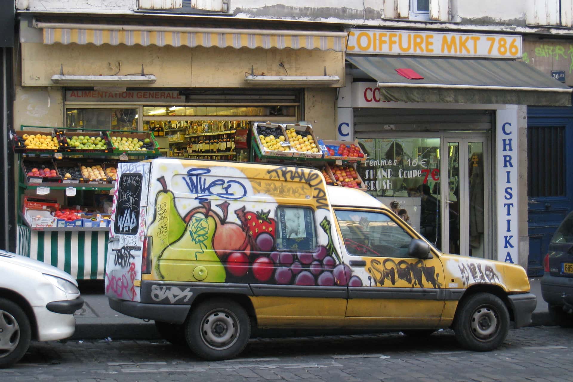 assorted fruit painted on a truck in front of a grocery store in Paris