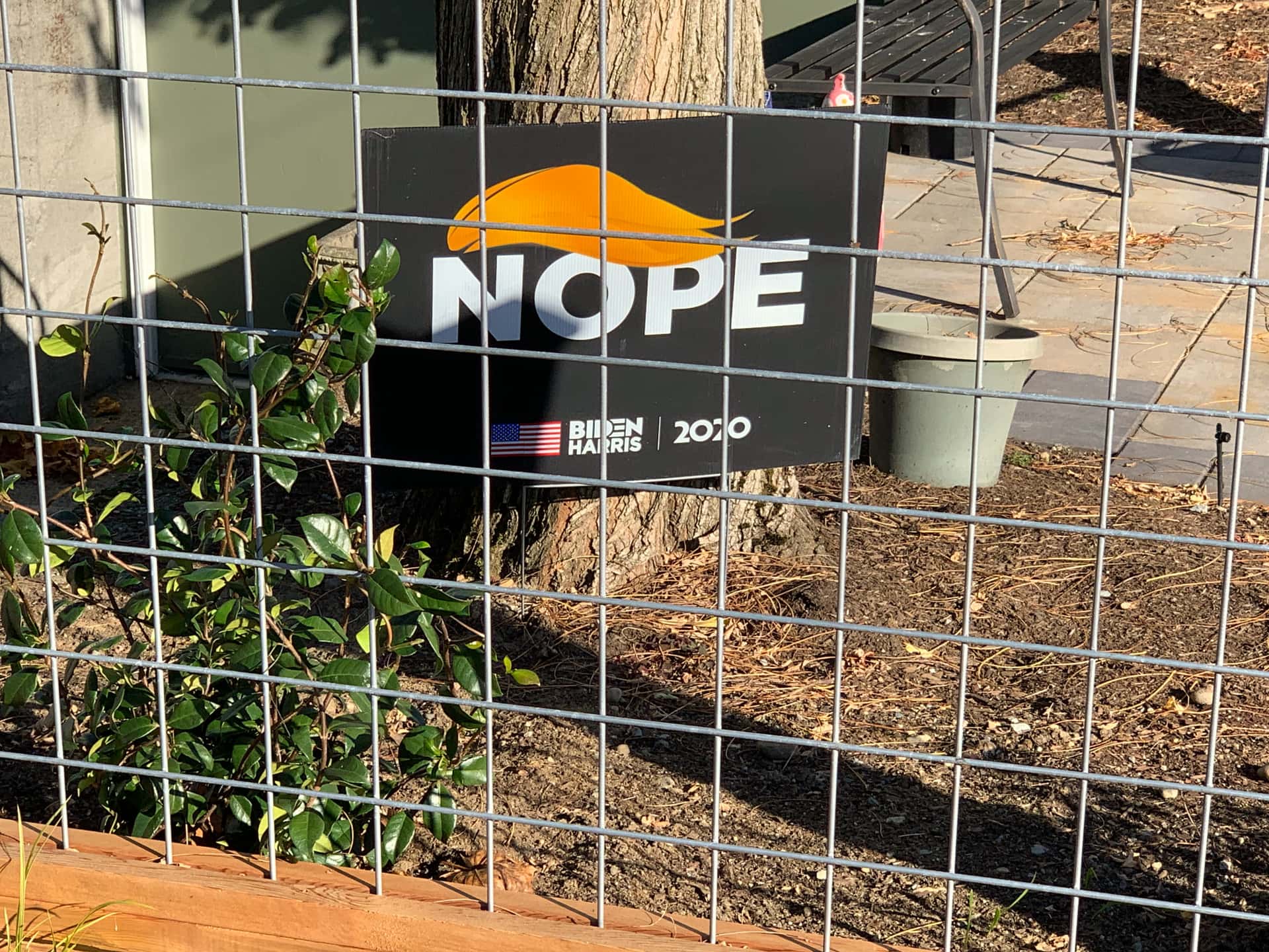 the word “NOPE” adorned with a caricature of Donald Trump’s hair on a yard sign