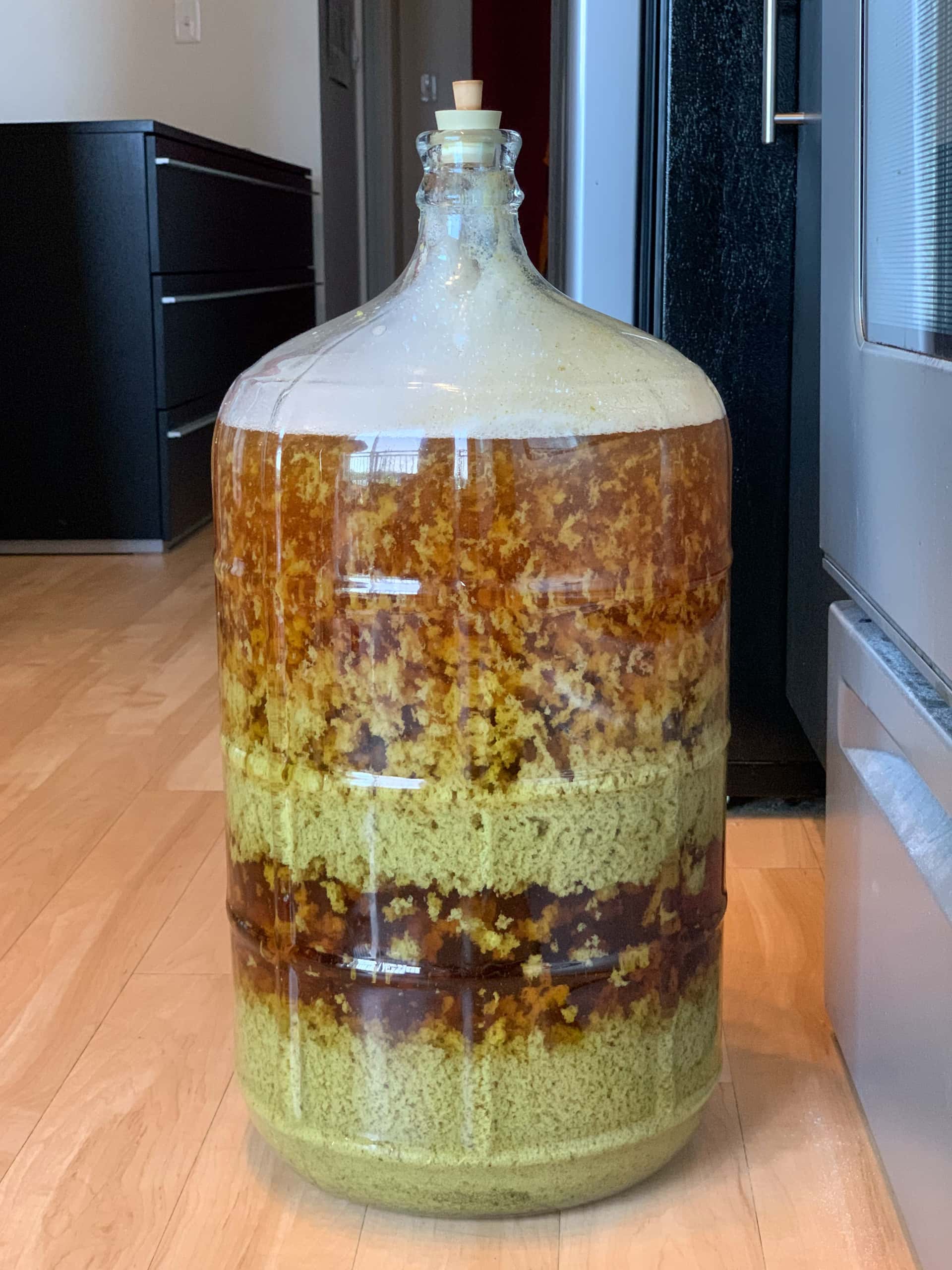 wort settling into layers in a glass carboy