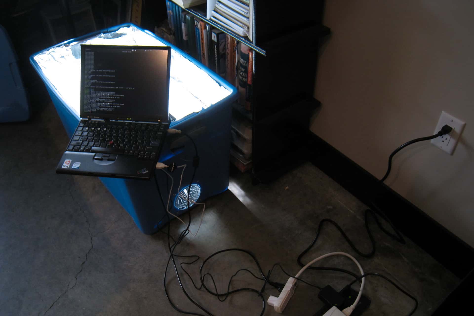 laptop perched atop a box that is emitting bright light