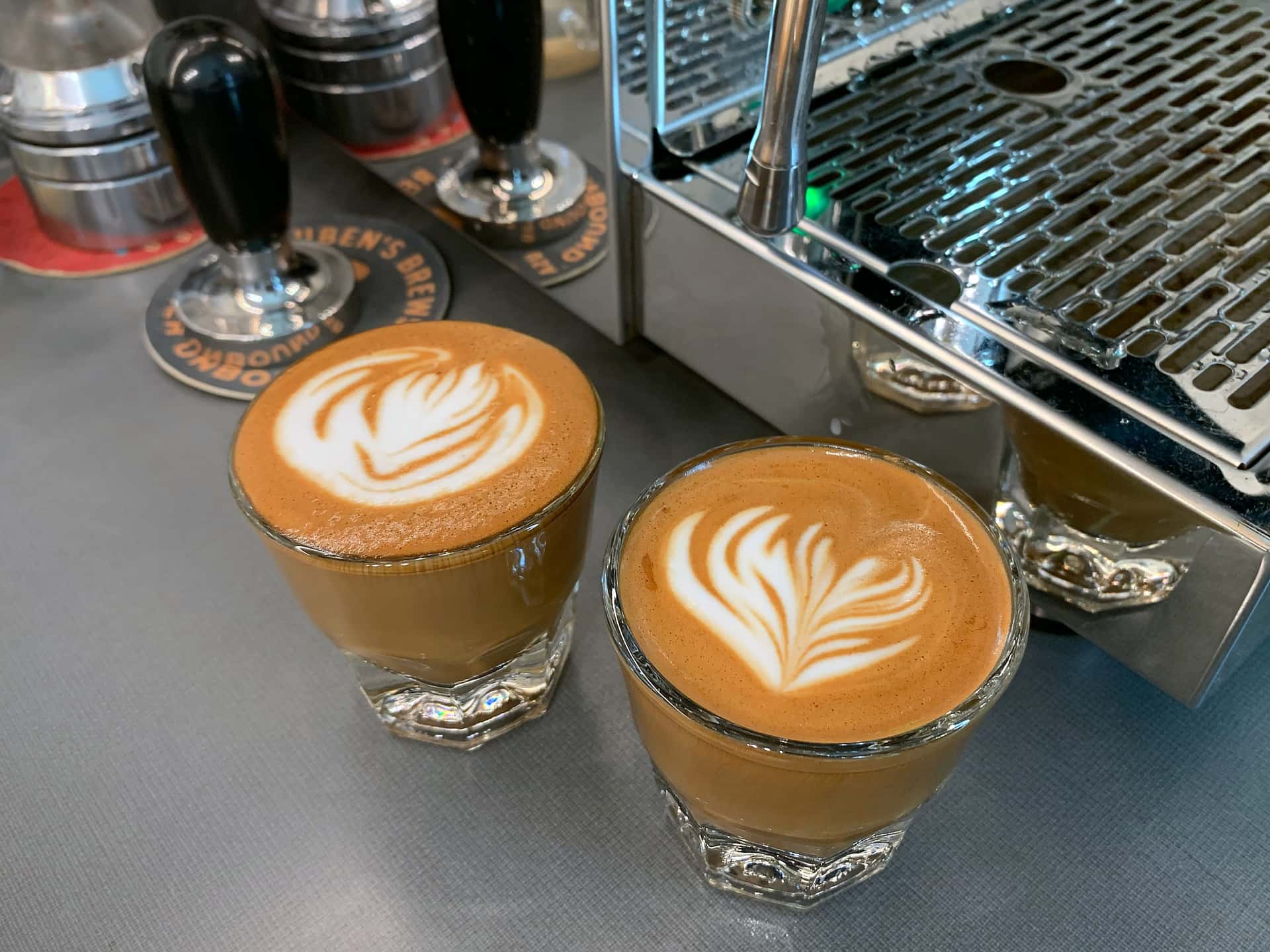 latte art on a pair of cortados