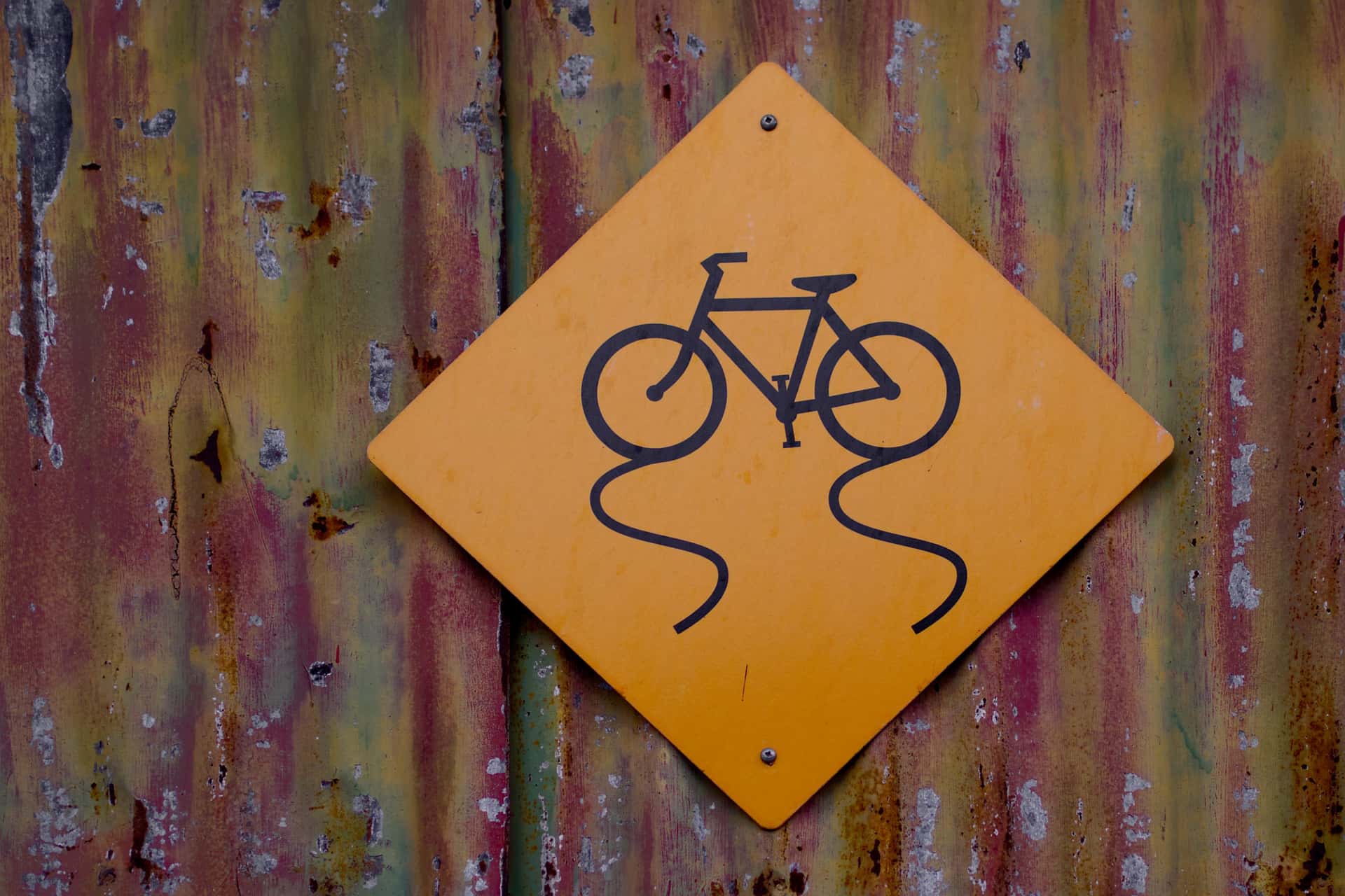 “slippery when wet” street sign for bicycles