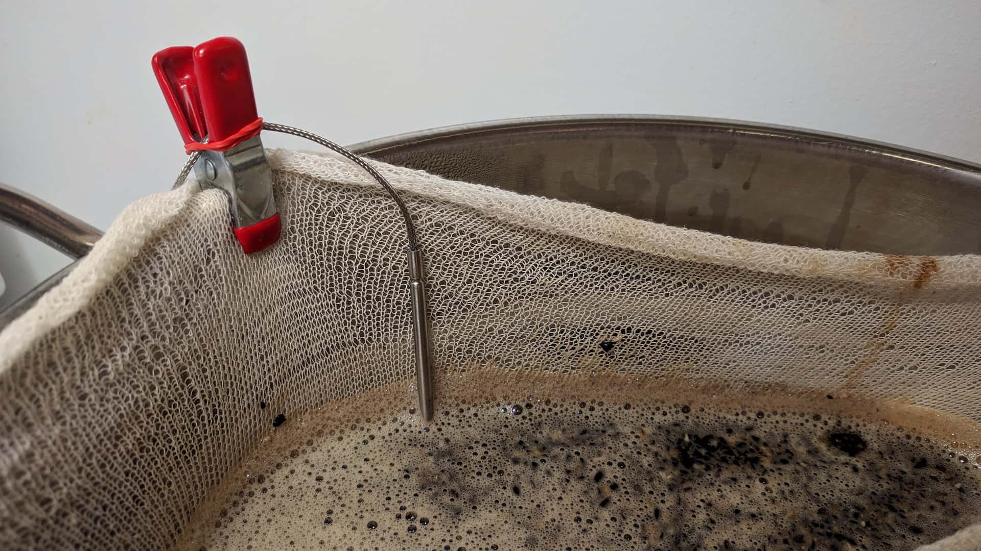 kitchen thermometer probing a partial mash
