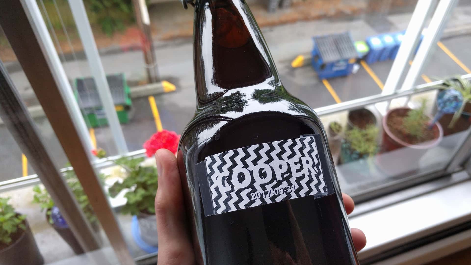 homebrew beer labeled with “Cooper” and a black and white zigzag pattern