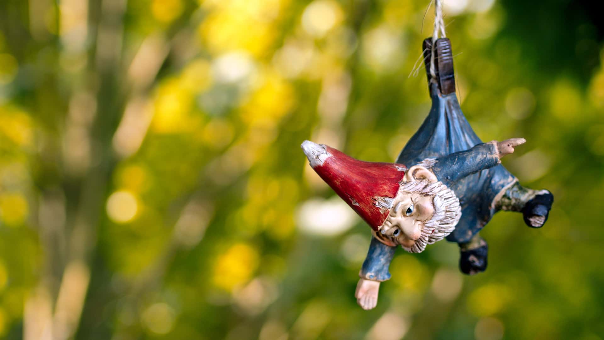 garden gnome suspended by a clothespin