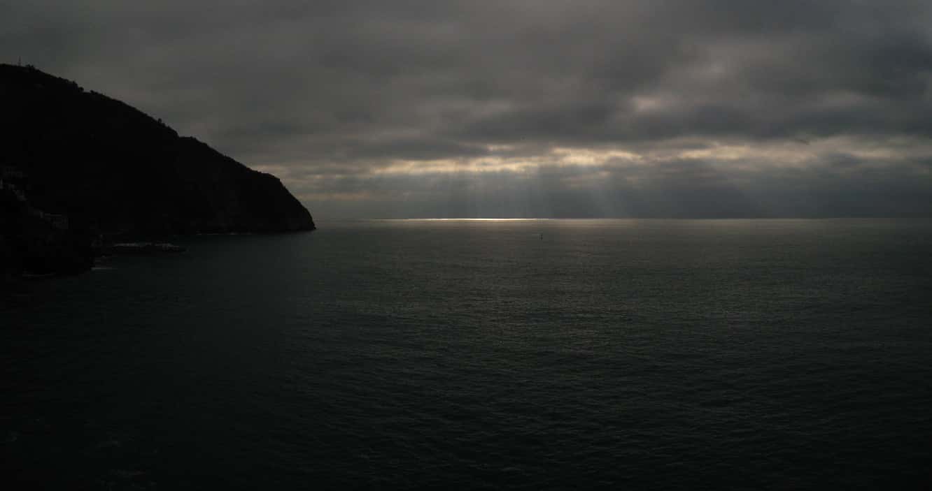 sunlight breaking through the clouds offshore from Cinque Terre