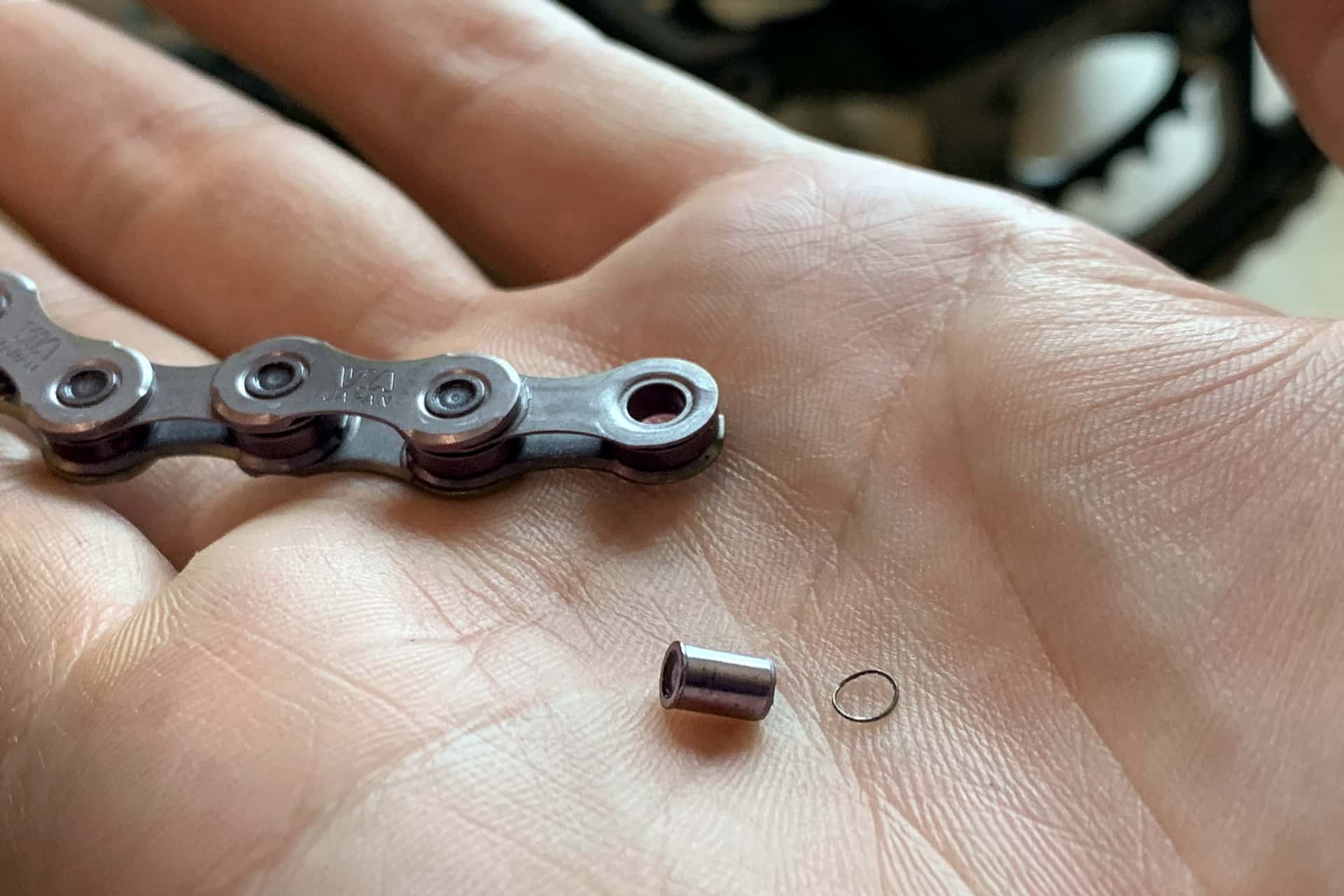 bicycle chain broken by shearing the rim off a pin