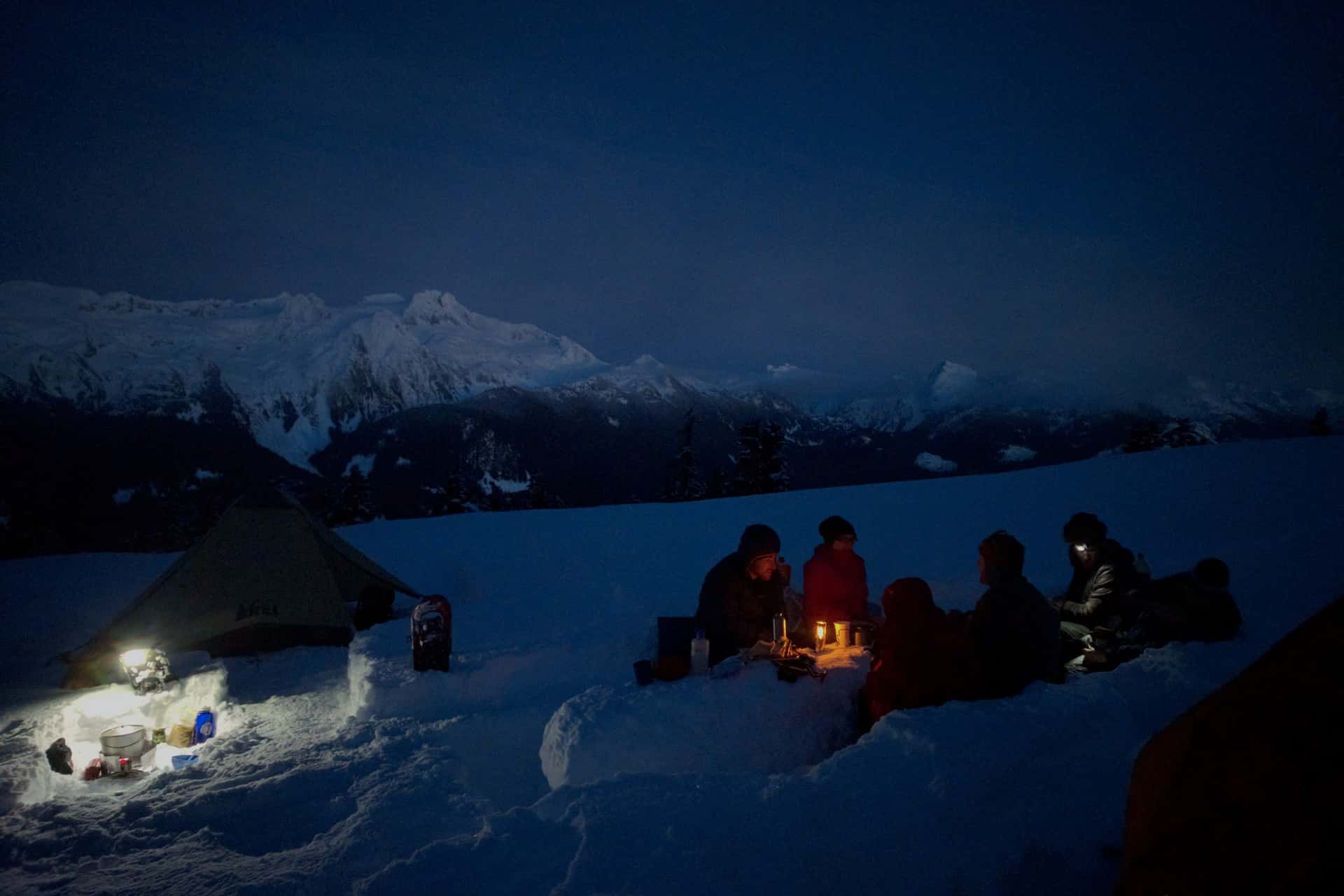 dining by lamplight around a table carved from snow at Elfin Lakes