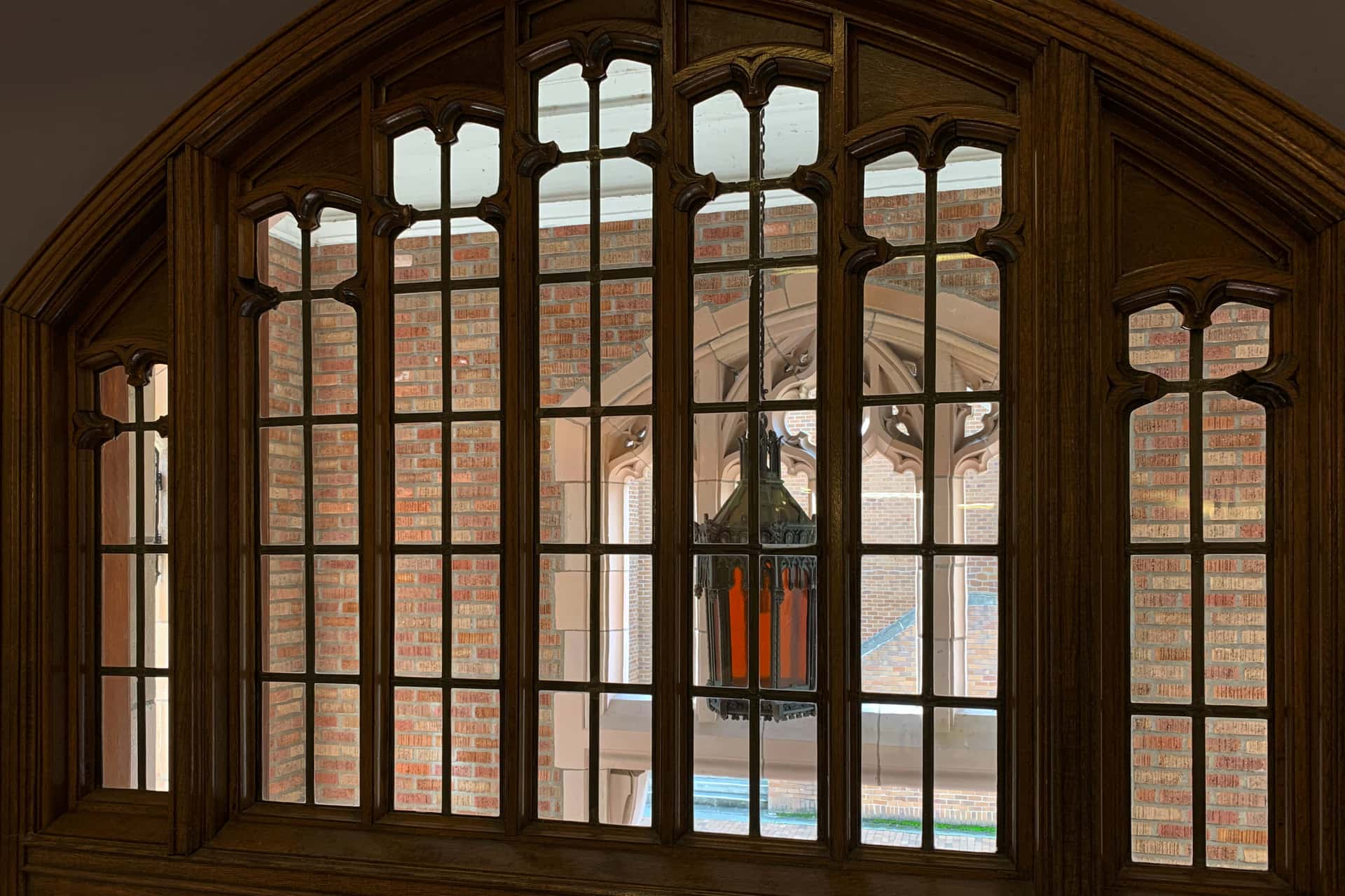 view of an ornamental lantern from a second-floor balcony into the high-ceilinged vestibule of Savery Hall